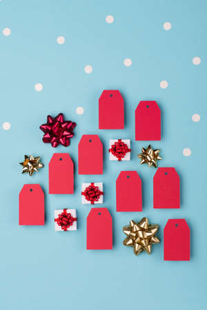 Festive winter holiday sale concept on blue paper background with Christmas gift boxes and red empty...