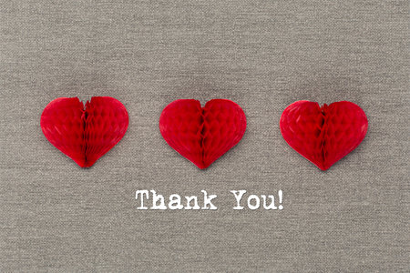 International Thank you day. Greeting card with craft red paper hearts on natural gray background. Thank you text card. Flat lay, top view, copy space.の写真素材