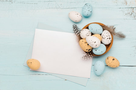 Easter craft eggs and branches on blue pastel background with space for text. Flat lay image...