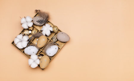 Easter eggs on beige pastel background with space for text. Flat lay image composition, top view....