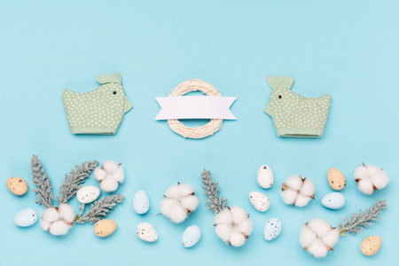 Craft Easter eggs on blue pastel background, space for text. Flat lay image composition, top view....