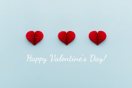 Valentine's Day holiday card. Red small paper hearts on pastel blue background. Valentines day...