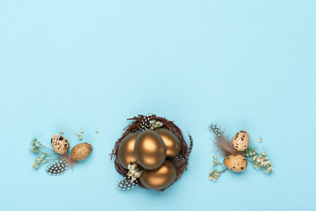 Festive Easter holiday greeting card background. Easter Decoration with golden eggs, quail feathers,...