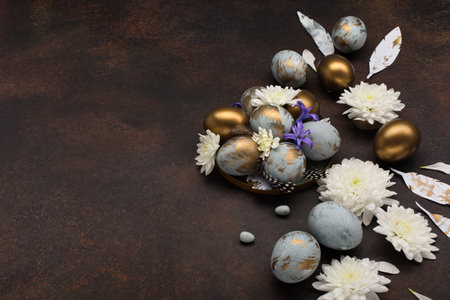 Festive Easter holiday greeting card. Easter Decoration with gray blue golden eggs, quail feathers,...