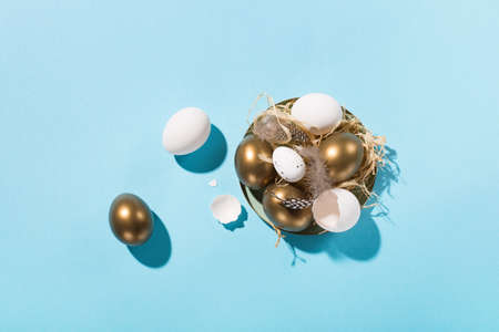 Festive Easter holiday greeting card background. Easter white golden eggs, quail eggs and feathers...