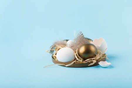Festive Easter holiday greeting card background. Easter white golden eggs, quail eggs and feathers...