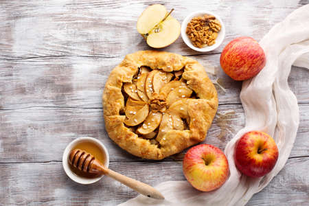 Homemade crostata pie with ripe apples, nuts and maple syrupの写真素材