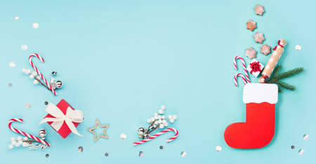 St. Nicholas Day - Red boot with sweets, spicy ginger cookies and gifts for December 6th on blue...