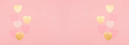 Pink, golden paper hearts on pink background. Valentines day banner concept. Flat lay, top view, copy space. Festive holiday greeting card for Valentines, Birthday, Woman or Mothers Day.の写真素材