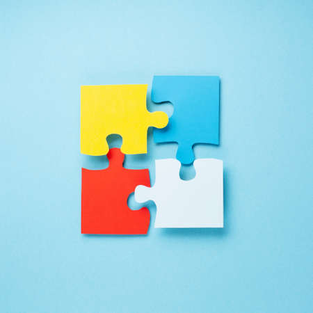 World Autism Awareness Day or month concept. Creative design for April 2. Color puzzle, symbol of awareness for autism spectrum disorder on blue background. Top view, copy space for text.の写真素材