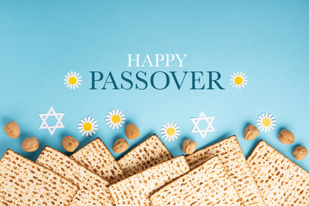 Jewish holiday Passover greeting card concept with matzah, nuts and tulip flowers on blue table....