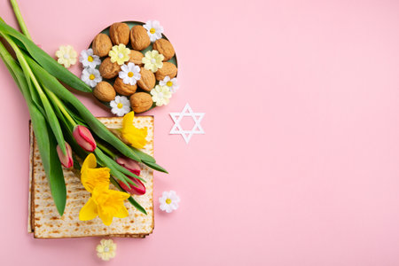 Jewish holiday Passover greeting card concept with matzah, Star of David, spring yellow daffodil,...