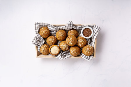 Gluten Free Homemade Bread Buns. Healthy eating, dieting, balanced food concept. Cereals gluten-free (millet, quinoa, buckwheat), psyllium husks, flax seeds, sunflower seeds on marble background.の写真素材