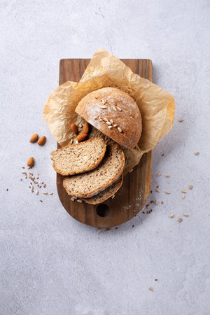 Gluten Free Homemade Bread. Healthy eating, dieting, balanced food concept. Cereals gluten-free, millet, quinoa, almond, buckwheat, flax seeds, sunflower seeds on gray background. ancient grain food.の写真素材