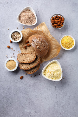 Gluten Free Homemade Bread. Healthy eating, dieting, balanced food concept. Cereals gluten-free, millet, quinoa, almond, buckwheat, flax seeds, sunflower seeds on gray background. ancient grain food.の写真素材