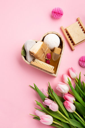 Natural eco friendly beauty skin care products, spa accessories for women and spring tulip flowers on pink background. Zero waste self care heart shape gift box for mothers day, womans day, birthday.の写真素材
