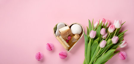 Natural eco friendly beauty skin care products, spa accessories for women and spring tulip flowers on pink background. Zero waste self care heart shape gift box for mothers day, womans day, birthday.の写真素材