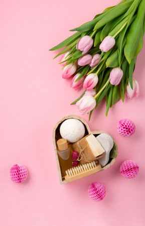 Natural eco friendly beauty skin care products, spa accessories for women and spring tulip flowers on pink background. Zero waste self care heart shape gift box for mothers day, womans day, birthday.の写真素材
