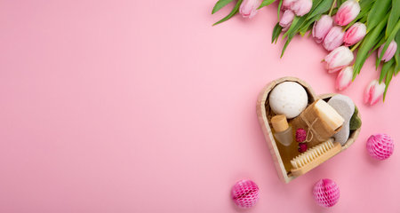 Natural eco friendly beauty skin care products, spa accessories for women and spring tulip flowers on pink background. Zero waste self care heart shape gift box for mothers day, womans day, birthday.の写真素材