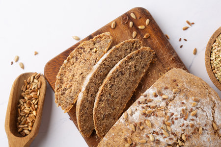 ancient grain food. Gluten free Bread, Healthy eating, dieting, balanced food concept. Cereals gluten-free, millet, quinoa, polenta, buckwheat, flax seeds, sunflower seeds on white background.の写真素材