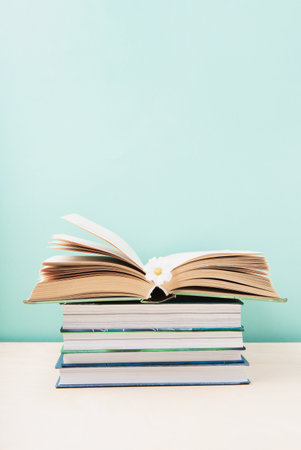World book and Copyright day, Education concept. Stack of books on blue mint background. Festive card for books holiday, copy space.の写真素材