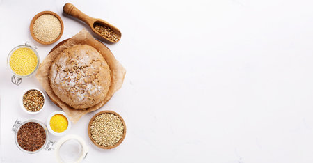 ancient grain food. Gluten free Bread, Healthy eating, dieting, balanced food concept. Cereals gluten-free, millet, quinoa, polenta, buckwheat, flax seeds, sunflower seeds on white background.の写真素材