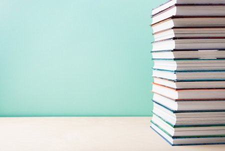 World book and Copyright day, Education concept. Stack of books on blue mint background. Festive card for books holiday, copy space.の写真素材