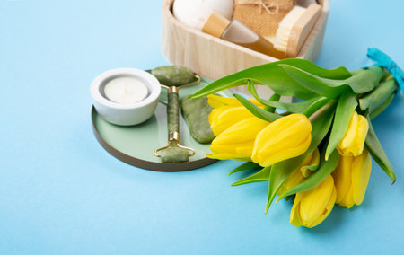 Natural eco friendly beauty skin care products, spa accessories for women and spring tulip flowers on blue background. Zero waste self care heart shape gift box for Mothers day, womans day, birthday.の写真素材