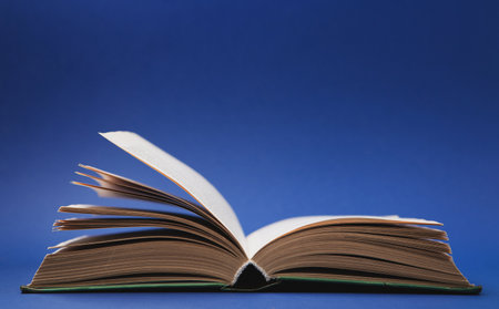 World book and Copyright day, Education concept. Open Book on dark blue background. Festive card for books holiday, copy space.の写真素材