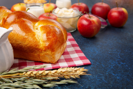 Happy Shavuot holiday card. Jewish religious holiday concept. Dairy products, fresh apples, cheese,...