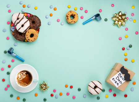 Fathers day holiday card concept with craft gift box, black mustache, cup of coffee and donuts or donuts on blue mint background, top view, copy space.の写真素材
