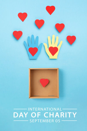 International Day of Charity, 5 September. Tolerance, kindness, cooperative, friendship, charity, humanitarian aid day concept. Colorful hands on blue background, copy space, top view.の写真素材
