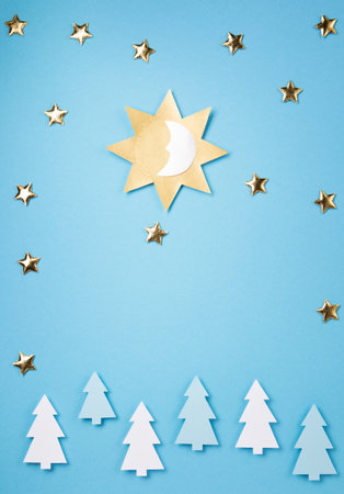 Winter solstice day holiday, December 21. Longest night in the year concept. Sun, moon and golden stars symbol on blue paper background. Flat lay, top view, copy spaceの写真素材