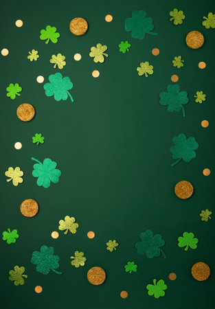 St Patricks day card with traditional symbols for irish party. Golden horseshoe, gold coins, clover leaves, green shamrocks on green background. Top view. St. Patrick's Day celebration concept.の写真素材