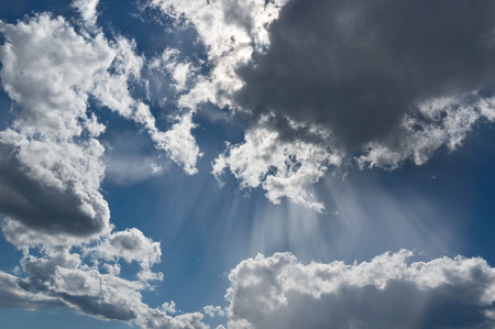 Sunbeams among clouds in the sky