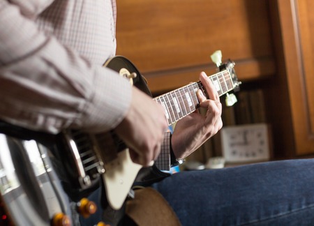 Practicing in playing guitarの写真素材