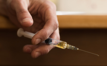 syringe in hand addiction, drugsの写真素材