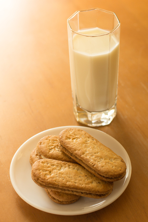 cookies and glass of fresh milk on the tableの写真素材