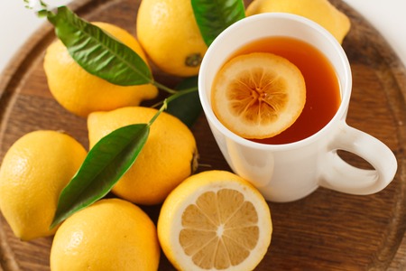 Black tea with lemon on a wooden board, closeup,isolated.の写真素材