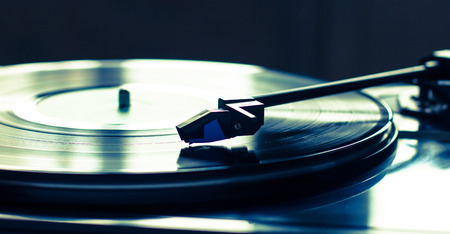 Vintage record player with vinyl disc, close-up.