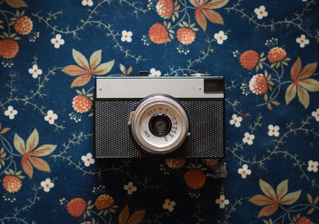 old vintage camera on a vintage fabric background.の写真素材