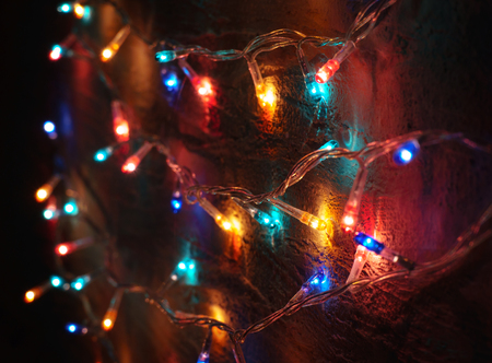 colored garland on the background of the old wall. atmospheric light bulbsの写真素材
