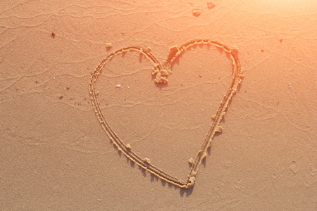 illustration of a heart drawn on sandの写真素材