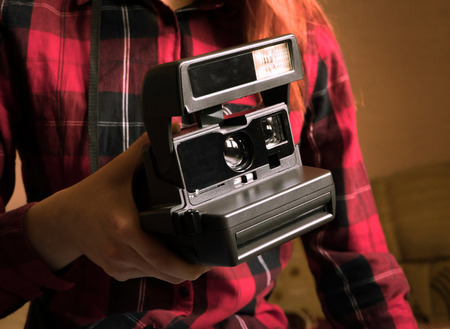young girl with retro camera. close-up