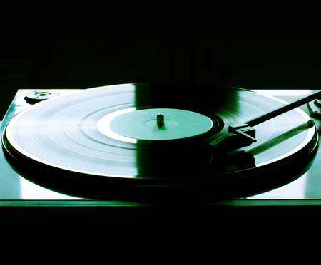 Vintage vinyl record player. green lighting