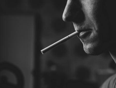 a guy with a cigarette in his mouth. closeupの写真素材