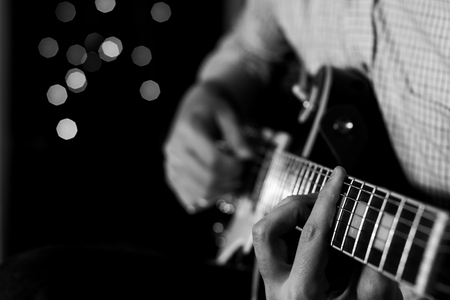 a young guy playing blues on an electric guitar. close-up