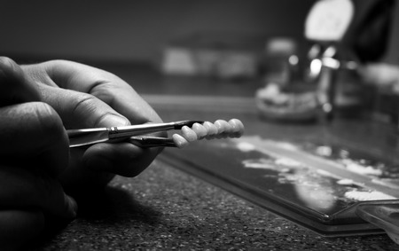 dental technician makes dental crowns. close-upの写真素材