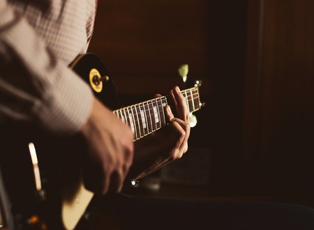 a young guy playing blues on an electric guitar. close-upの写真素材