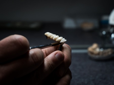 dental technician will design dental crowns. close-up. laboratory. macroの写真素材
